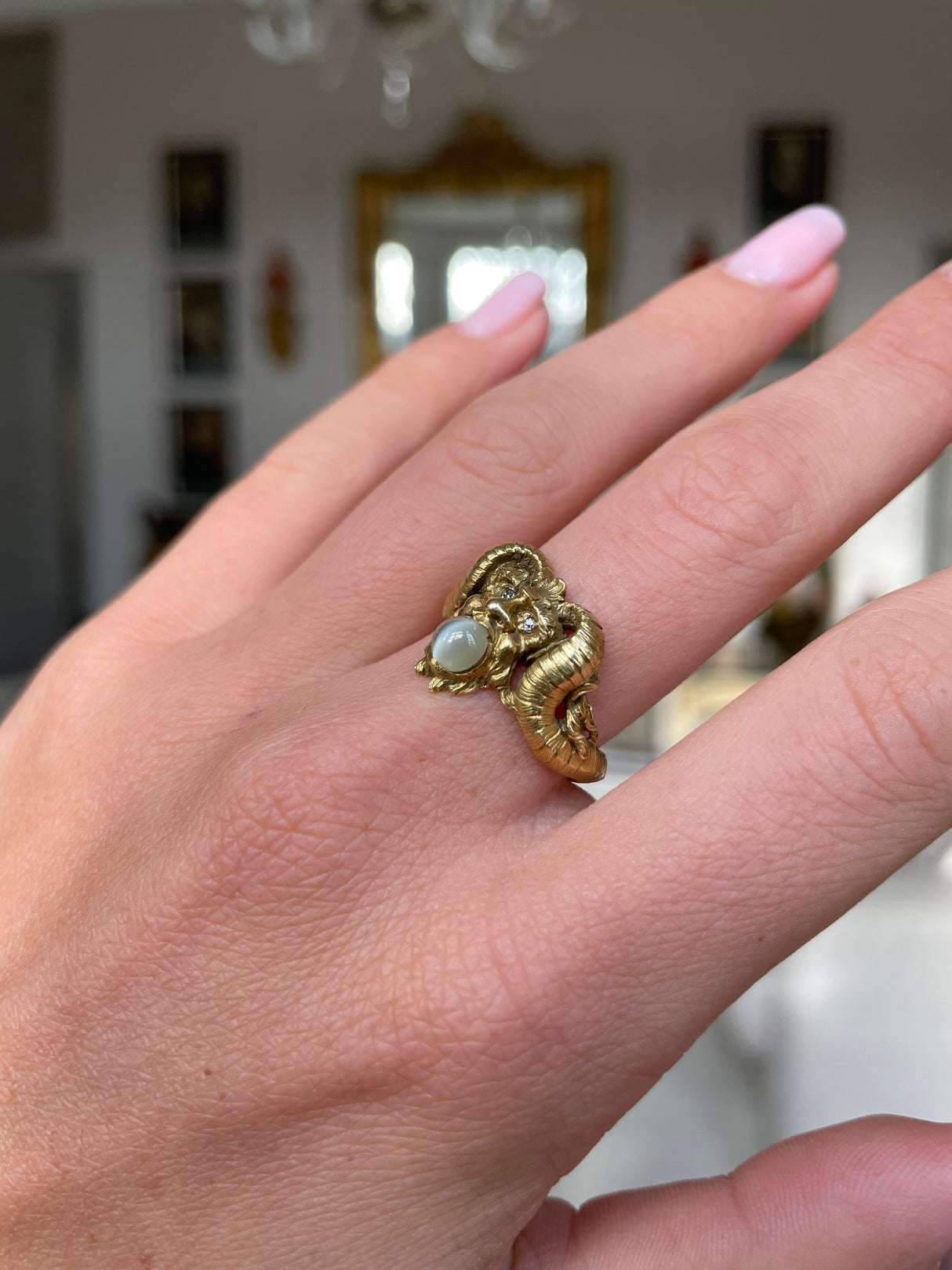 Early 20th century, 18ct gold, cabochon chrysoberyl and diamond 'faun' ring