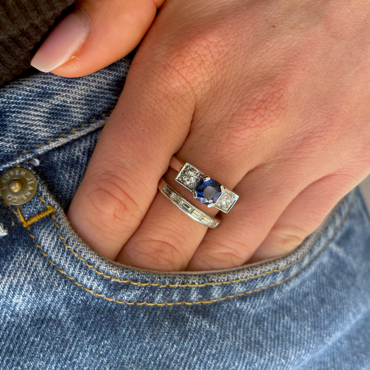 Art Deco three stone sapphire and diamond ring, worn on hand in pocket of jeans.