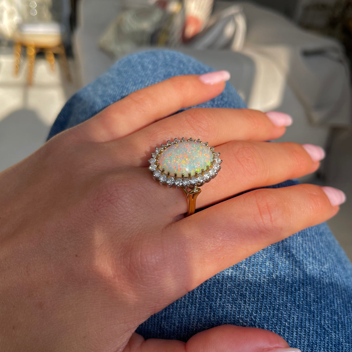 Vintage white Australian opal and diamond ring, worn on hand.