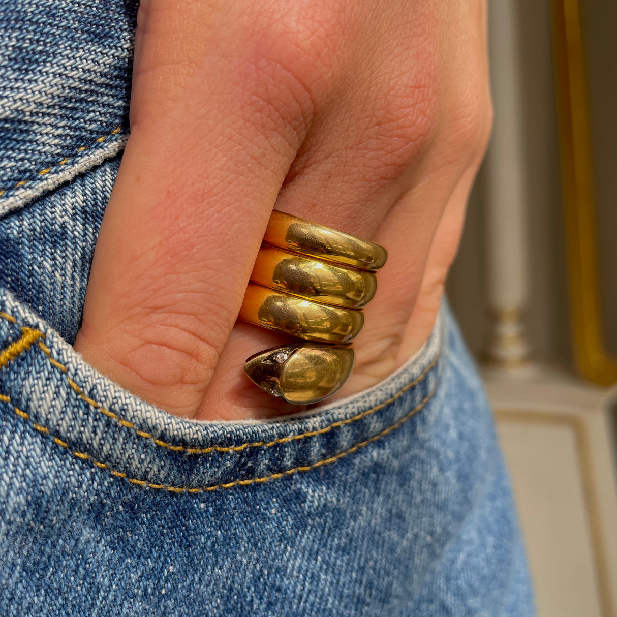 Victorian yellow gold snake ring, worn on hand.