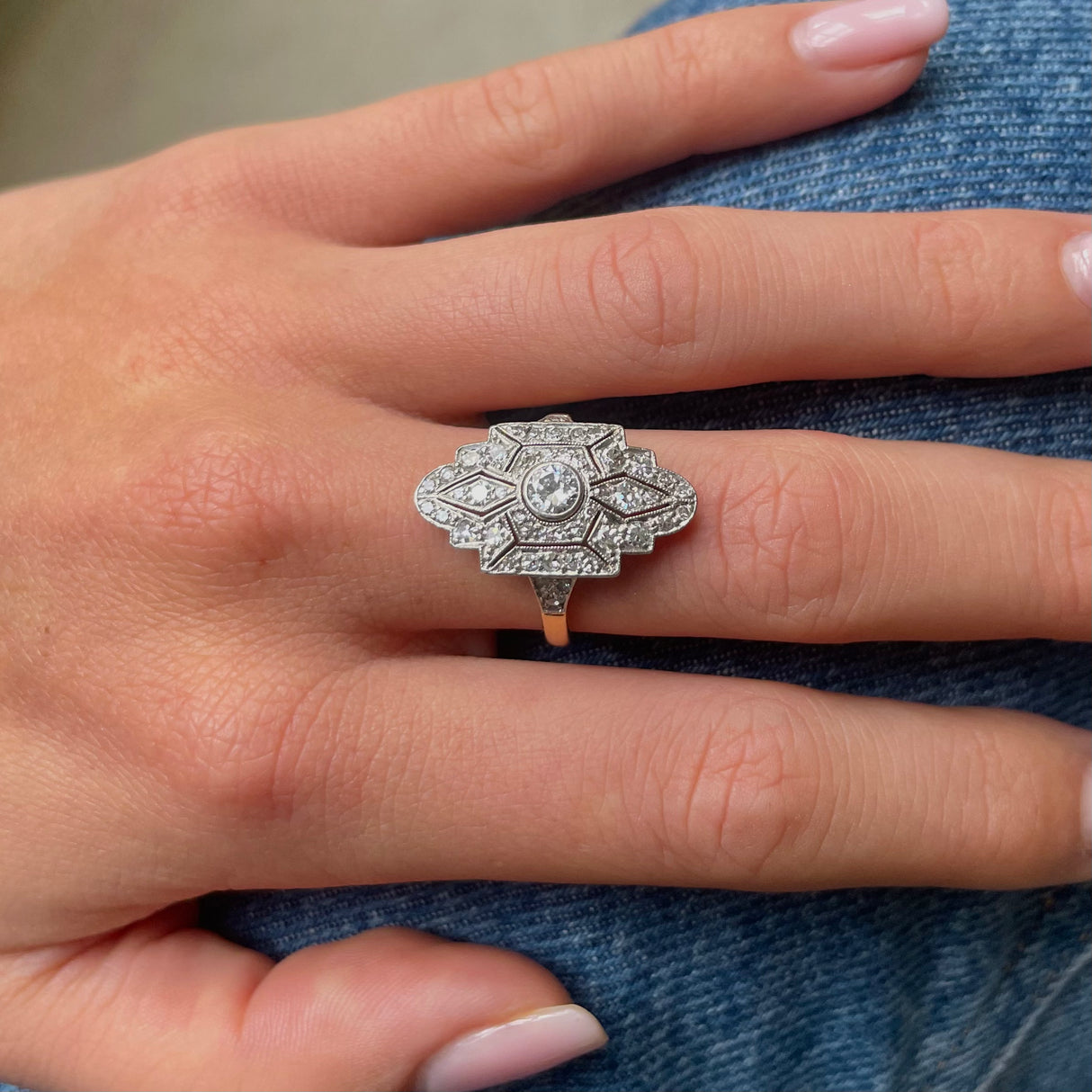 Art Deco diamond navette engagement ring, worn on hand.