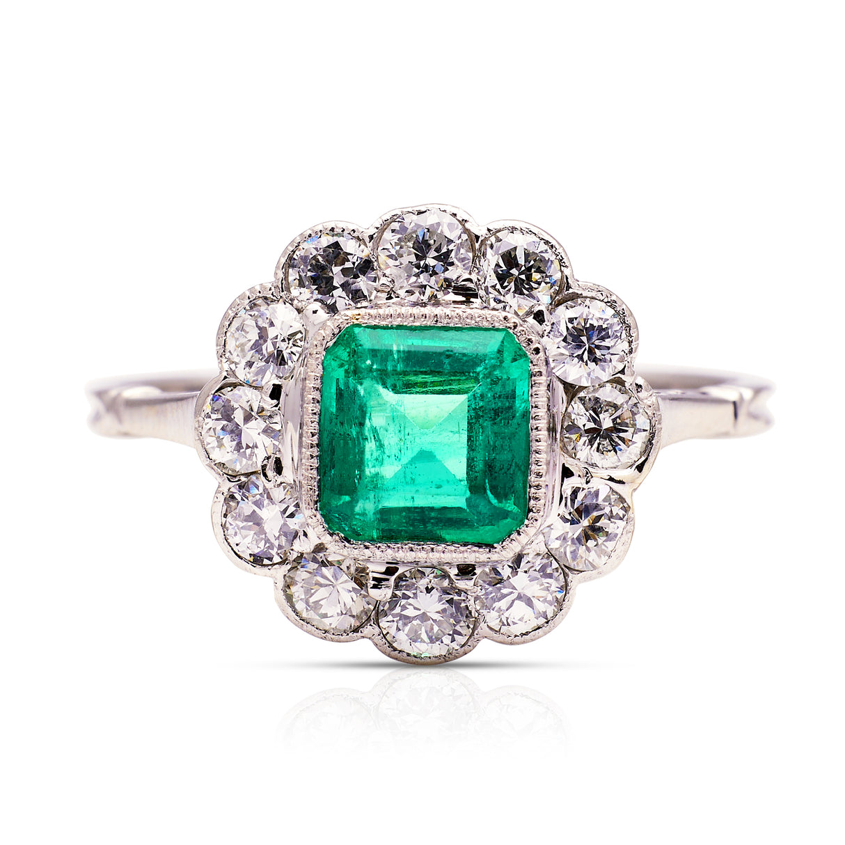 Edwardian emerald and diamond cluster ring, front view.