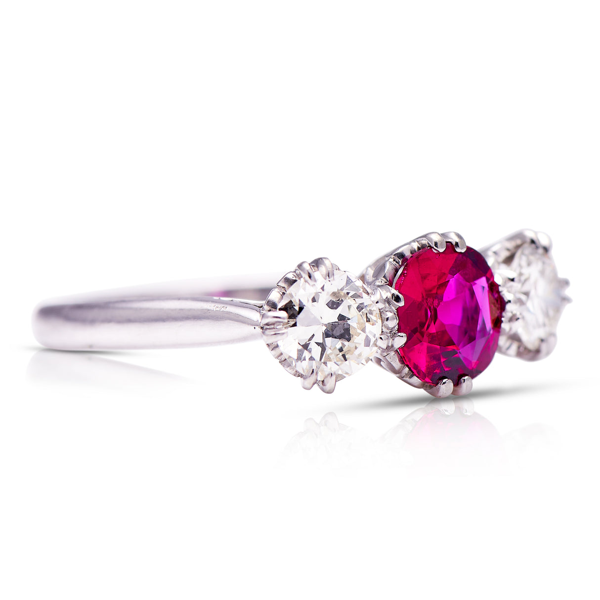 Ruby and diamond three-stone engagement ring, side view.