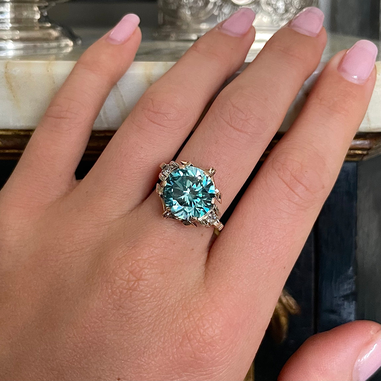 Art Deco zircon and diamond engagement ring, worn on hand.