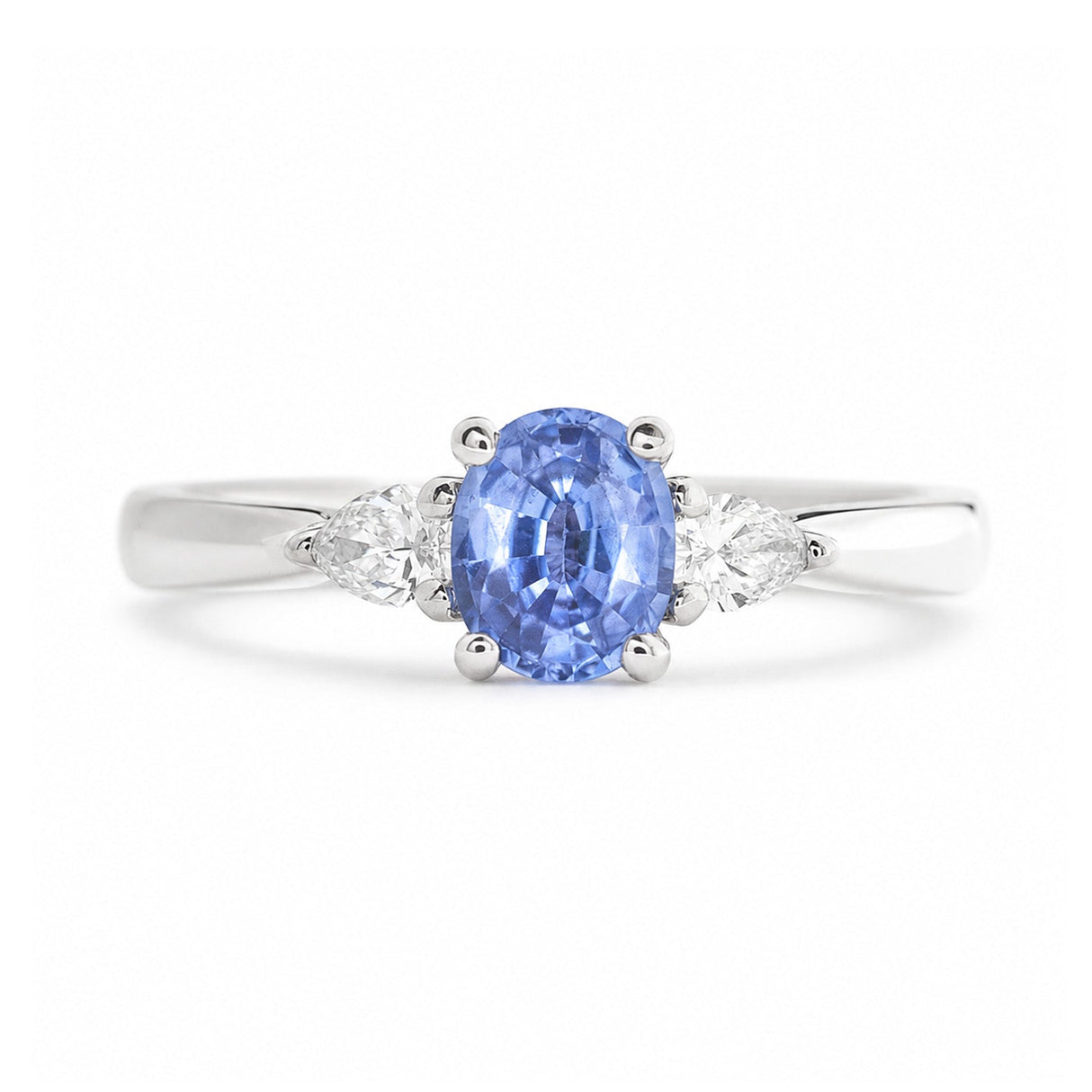 An antique-inspired light blue sapphire & diamond three-stone engagement ring in platinum.