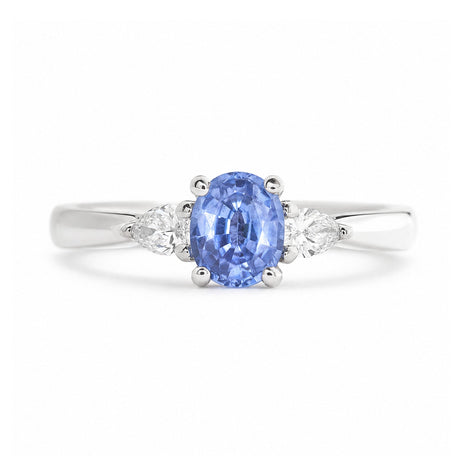 An antique-inspired light blue sapphire & diamond three-stone engagement ring in platinum.