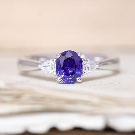 A vintage-inspired, indigo sapphire & diamond three-stone engagement ring in platinum.