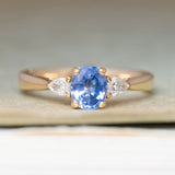 Vintage-inspired blue sapphire & diamond three-stone engagement ring in yellow gold. 