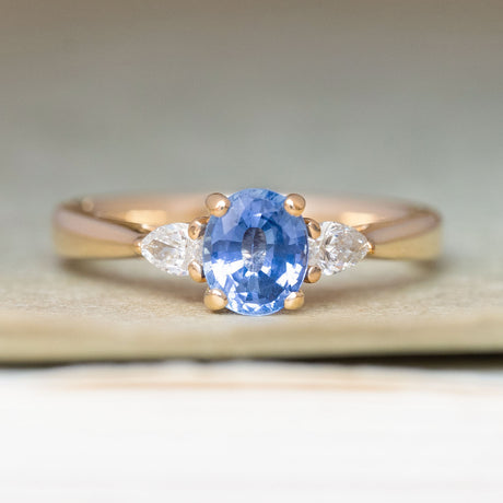 Vintage-inspired blue sapphire & diamond three-stone engagement ring in yellow gold. 