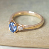 Antique-inspired blue sapphire & diamond three-stone engagement ring in yellow gold showing the three-quarter profile. 