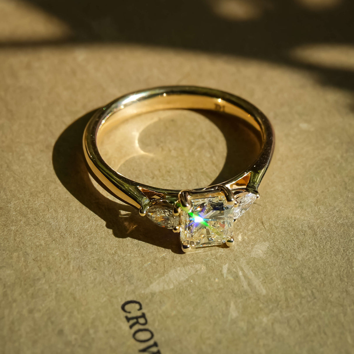 1.01ct yellow diamond and white diamond three stone engagement ring in yellow gold band