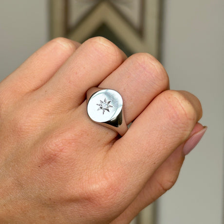 Vintage, 1980s diamond signet ring worn on hand.
