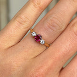 Antique, Edwardian ruby & diamond three-stone ring worn on hand.