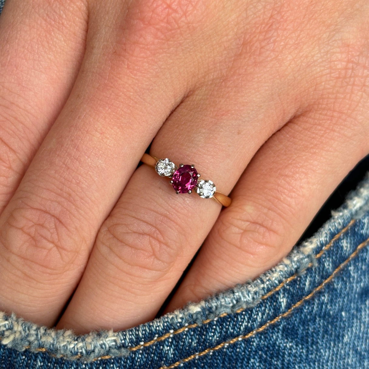 Antique, Edwardian ruby & diamond three-stone ring worn on hand.