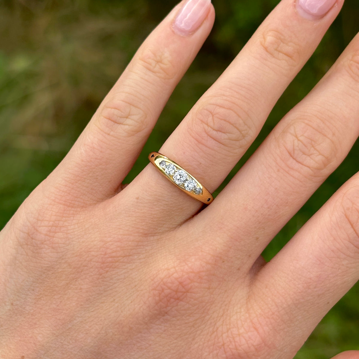 Antique, Edwardian five-stone diamond ring front worn on hand.