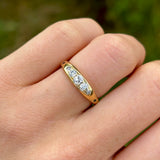Antique, Edwardian five-stone diamond ring front worn on hand.