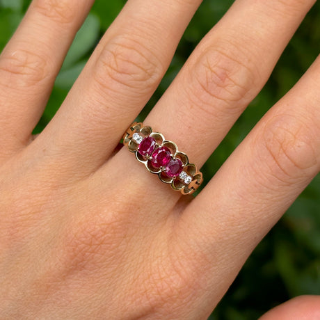 Vintage, 1980s ruby and diamond three-stone ring worn on hand.