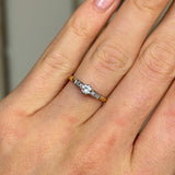 Antique, Edwardian solitaire diamond ring worn on hand.