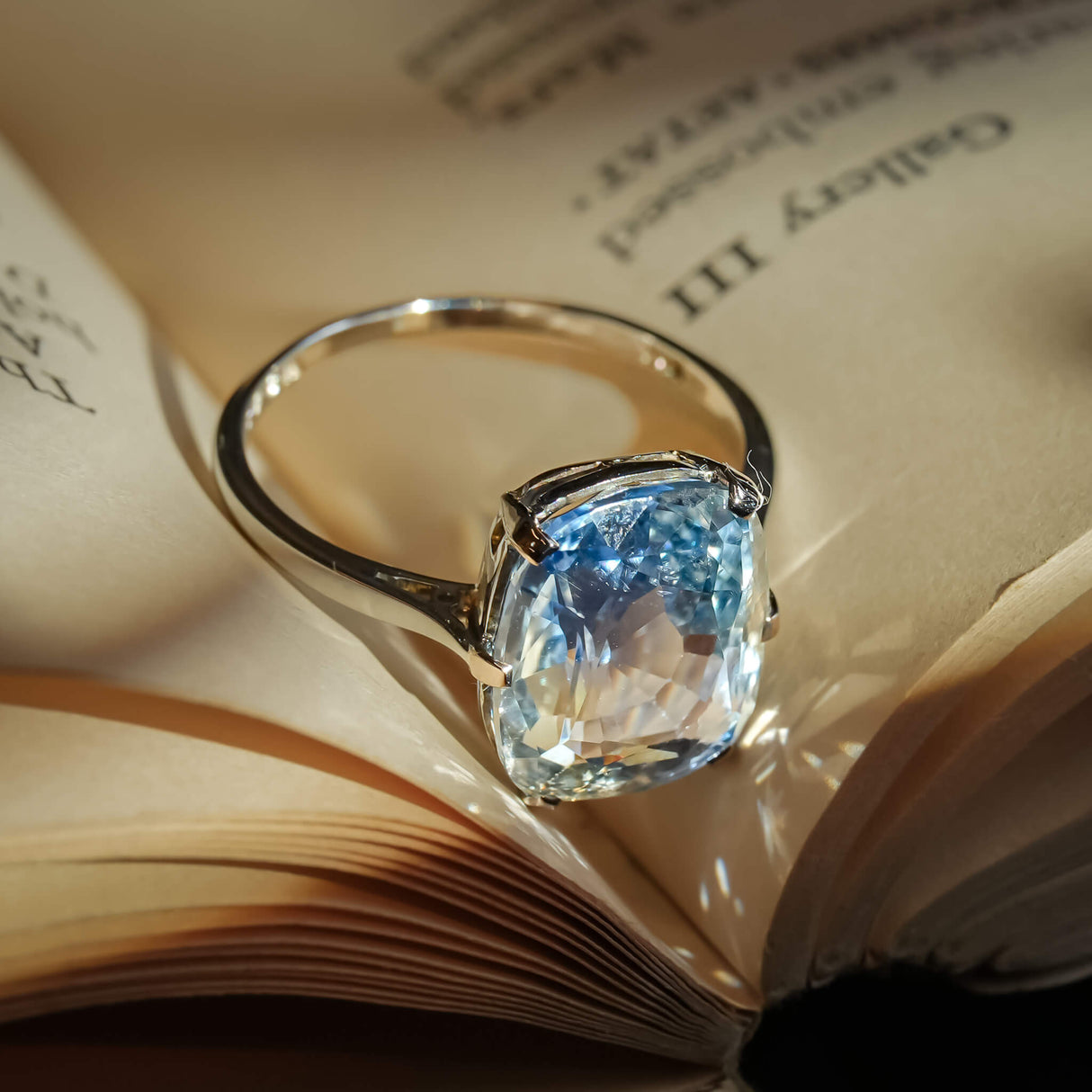 Antique 1920s sapphire solitaire ring featuring cushion cut blue gemstone