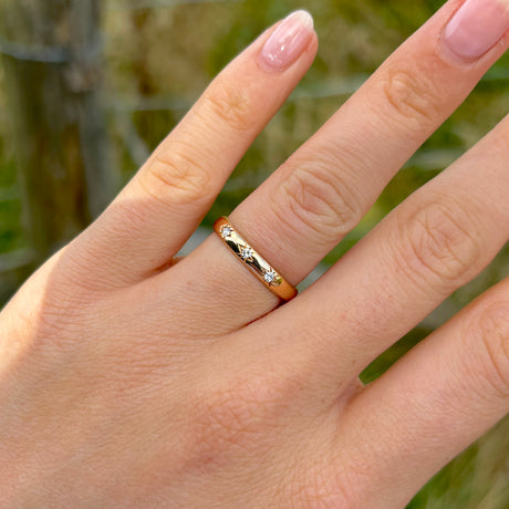 Vintage, 1960s three-stone diamond band worn on hand worn on hand.