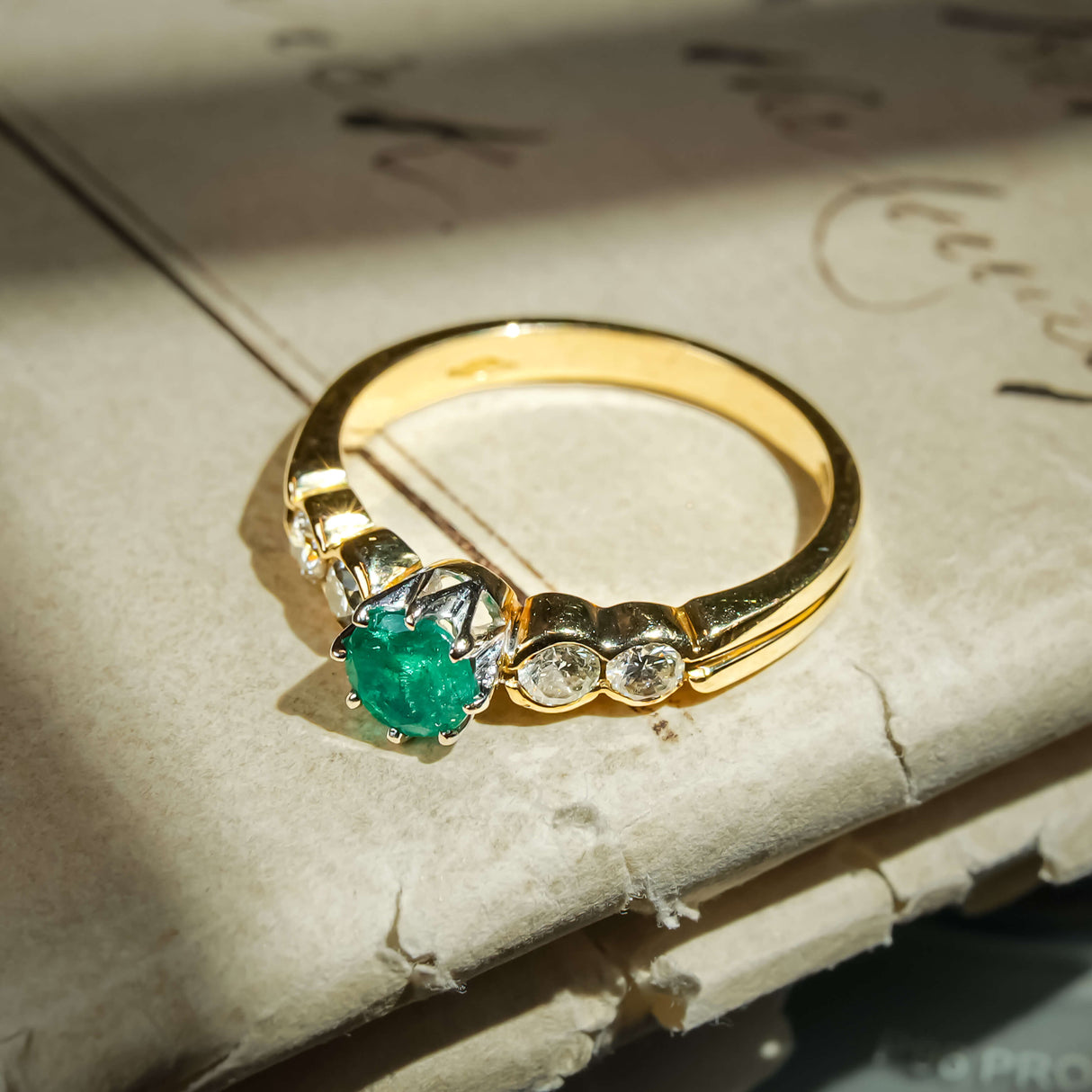 Vintage 1990s emerald and diamond ring with five stone setting and green emerald
