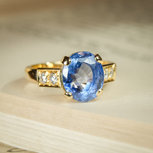 1990s sapphire and diamond engagement ring with oval blue gemstone