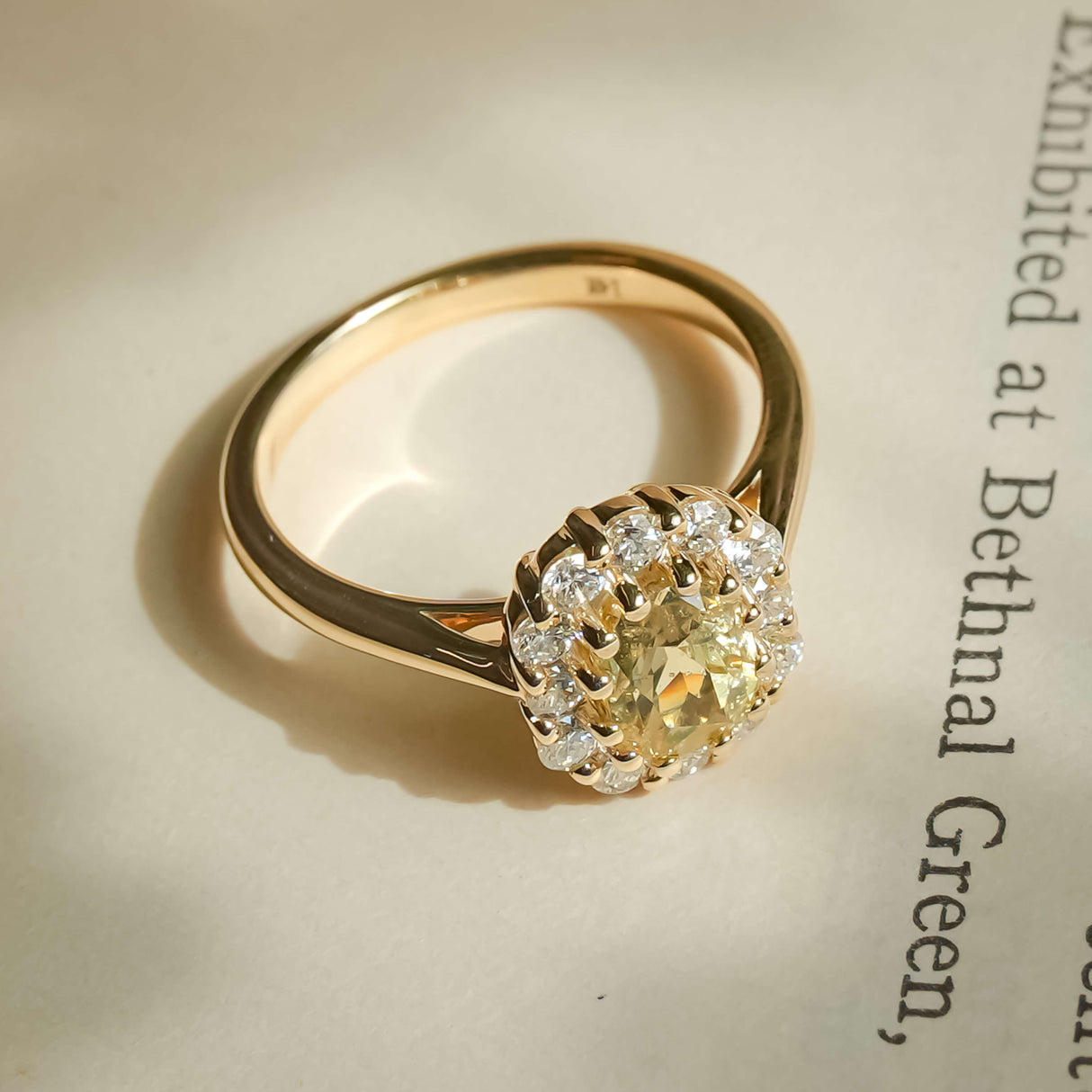 Yellow sapphire and diamond cluster engagement ring in yellow gold band