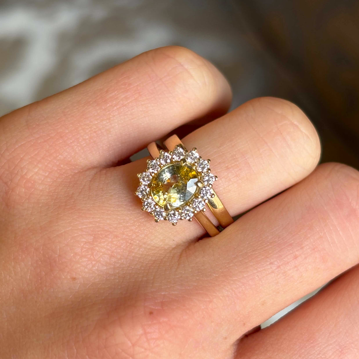 Yellow sapphire and diamond 18ct yellow gold cluster ring worn stacked with a wedding band showing proportions. 