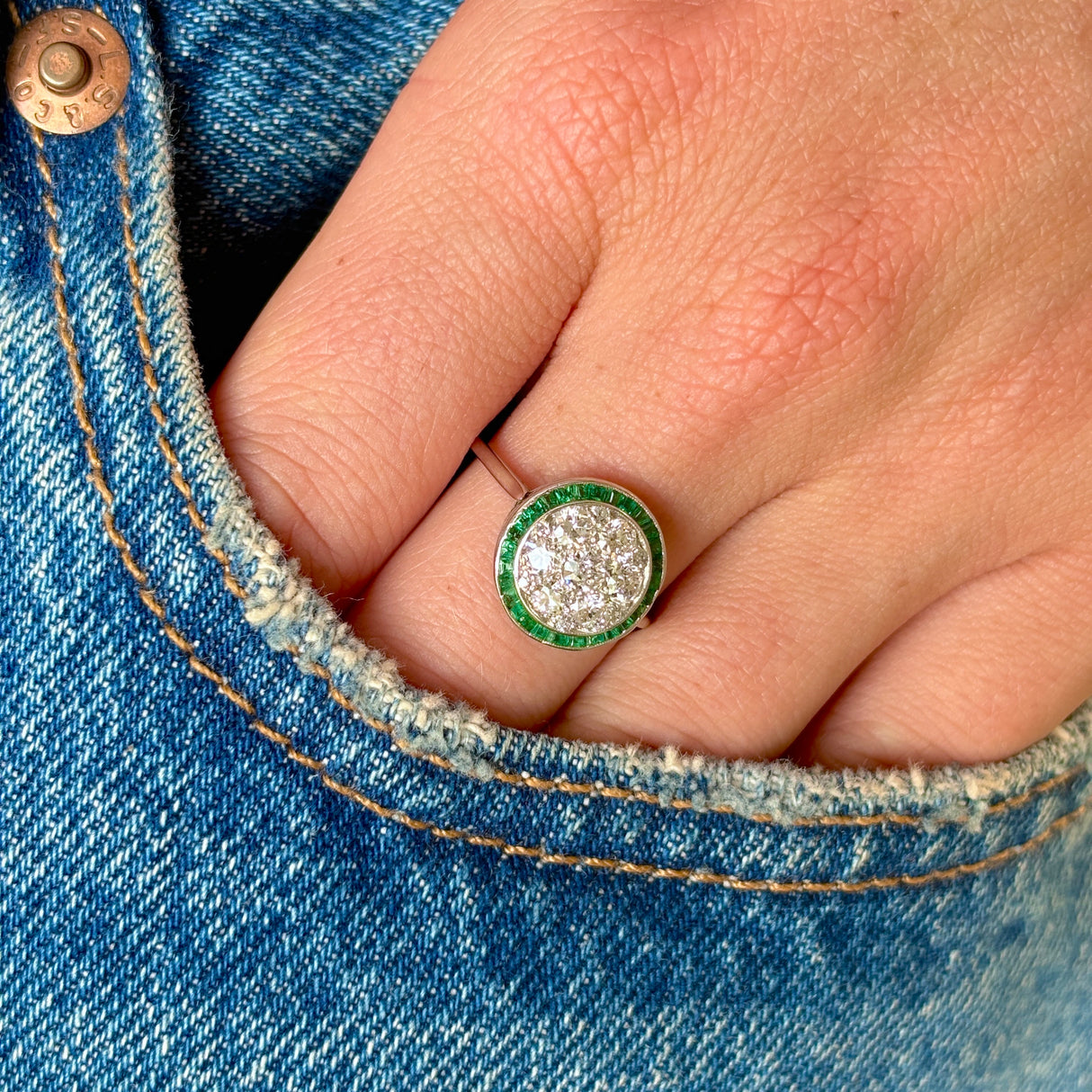 Vintage, Art Deco emerald & diamond target cluster ring worn on hand. 