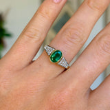 Vintage, 1970s inspired emerald & diamond ring worn on hand.
