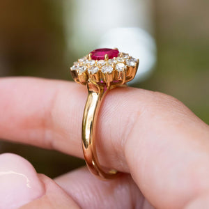 Side detail of a vintage 1980s Burmese ruby and diamond cluster ring in yellow gold.