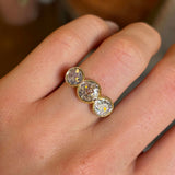 Antique, Victorian three-stone diamond ring worn on hand close up