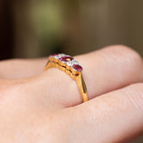 Side view of an antique Edwardian ruby and diamond five-stone ring in yellow gold.