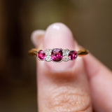 Close-up of an antique Edwardian five-stone ring featuring natural rubies and old-cut diamonds.