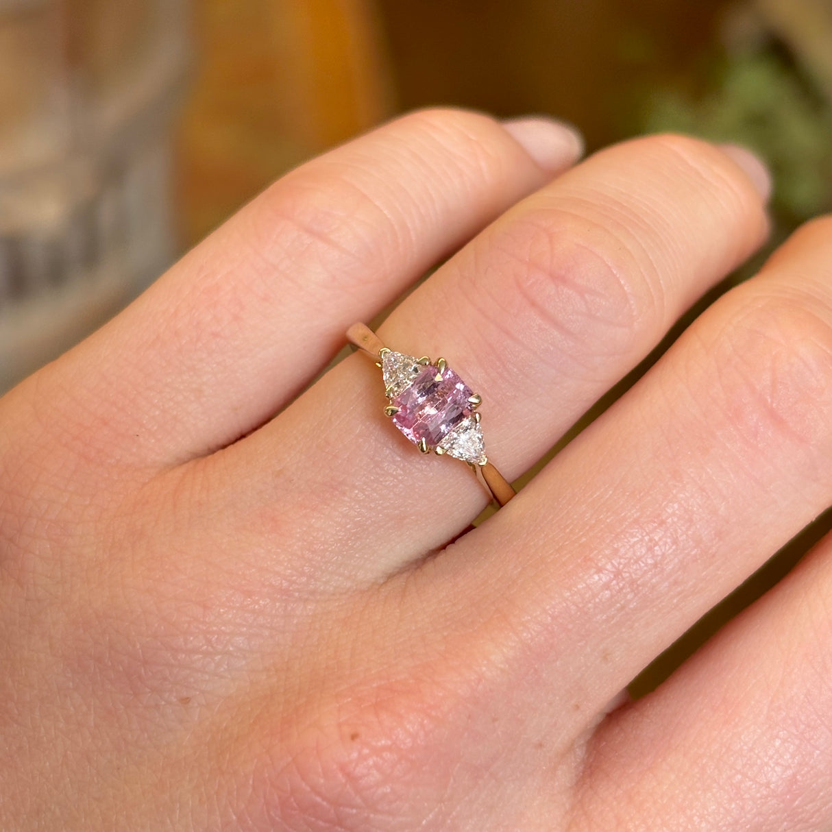 Pink sapphire and diamond three-stone engagement ring
