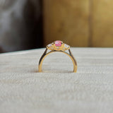 Pink sapphire and diamond three-stone engagement ring