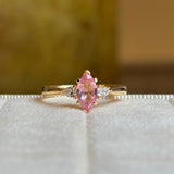 Pink sapphire and diamond three-stone engagement ring