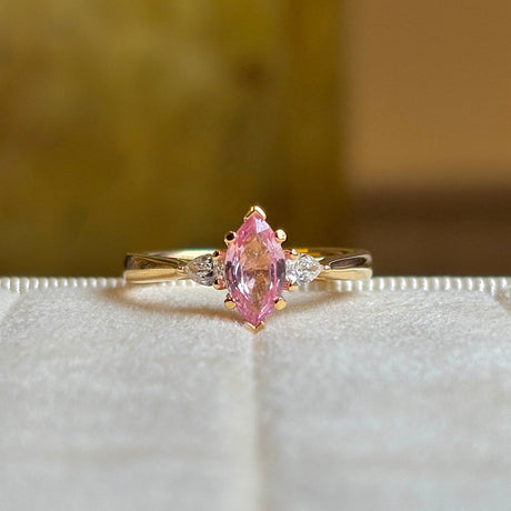 Pink sapphire and diamond three-stone engagement ring