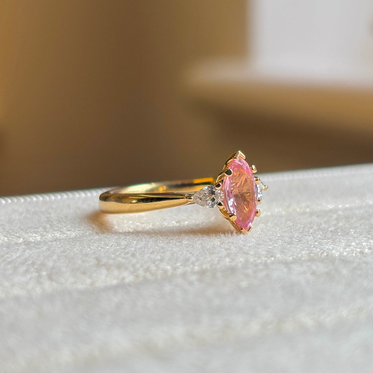 Pink sapphire and diamond three-stone engagement ring