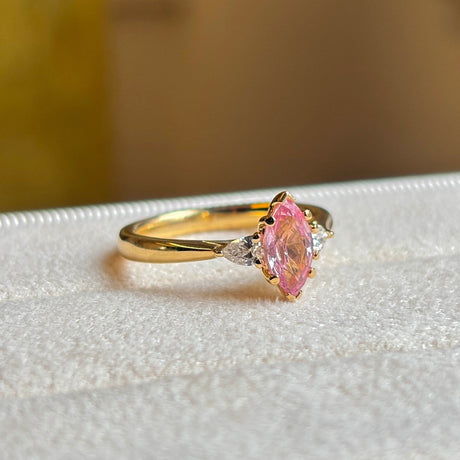 Pink sapphire and diamond three-stone engagement ring