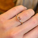 Pink sapphire and diamond three-stone engagement ring