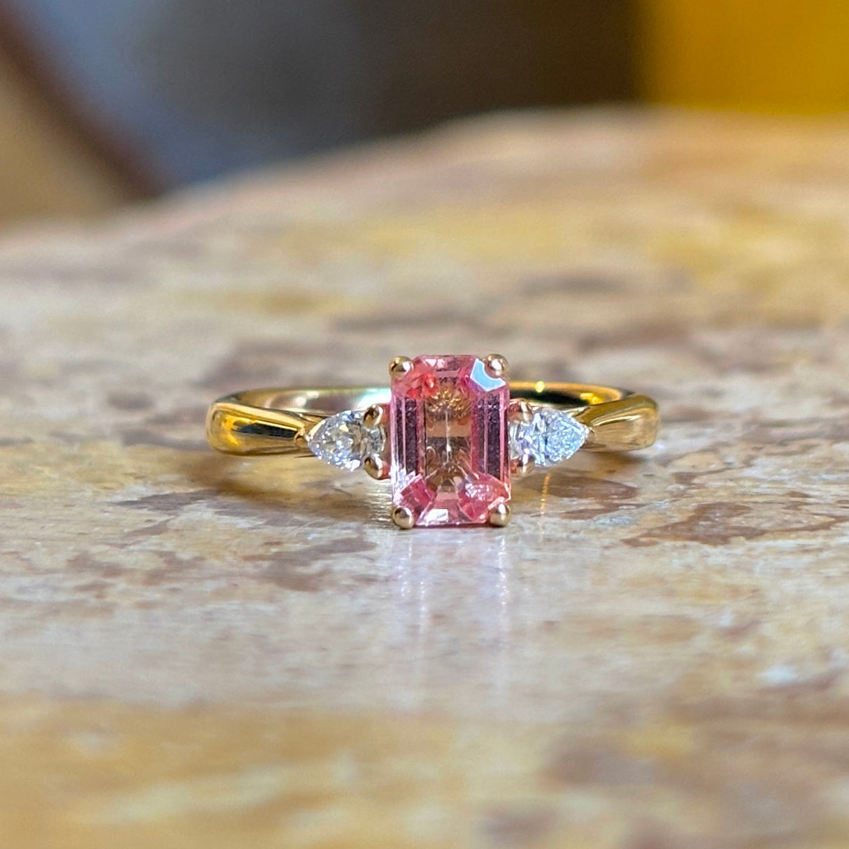 Pink sapphire and diamond three-stone engagement ring