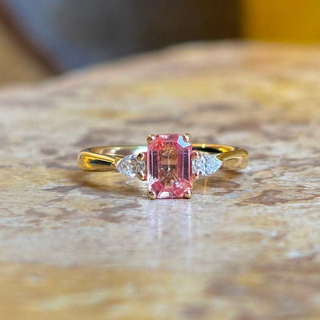 Pink sapphire and diamond three-stone engagement ring