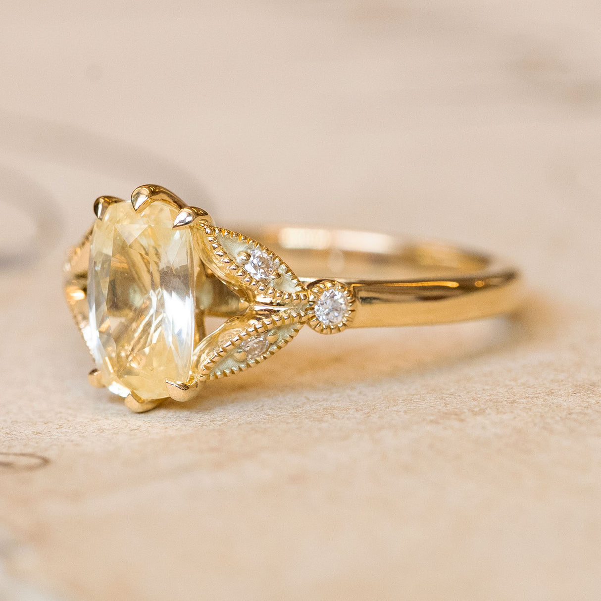 Vintage-inspired yellow cushion cut sapphire & diamond engagement ring in 14ct yellow gold. 