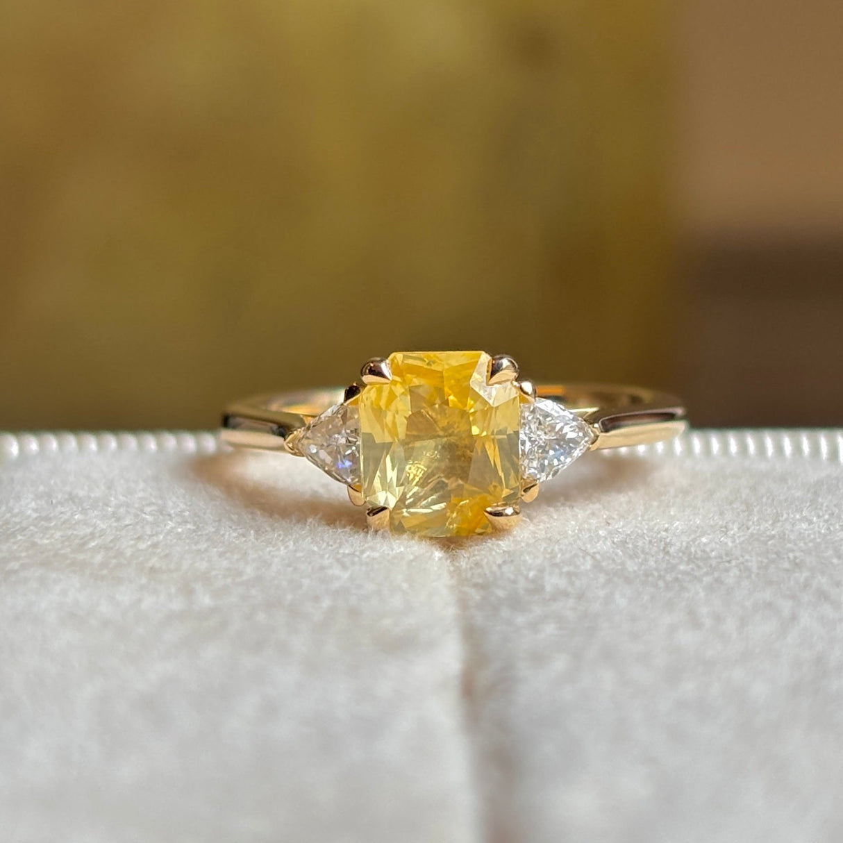 Yellow sapphire and diamond three-stone ring