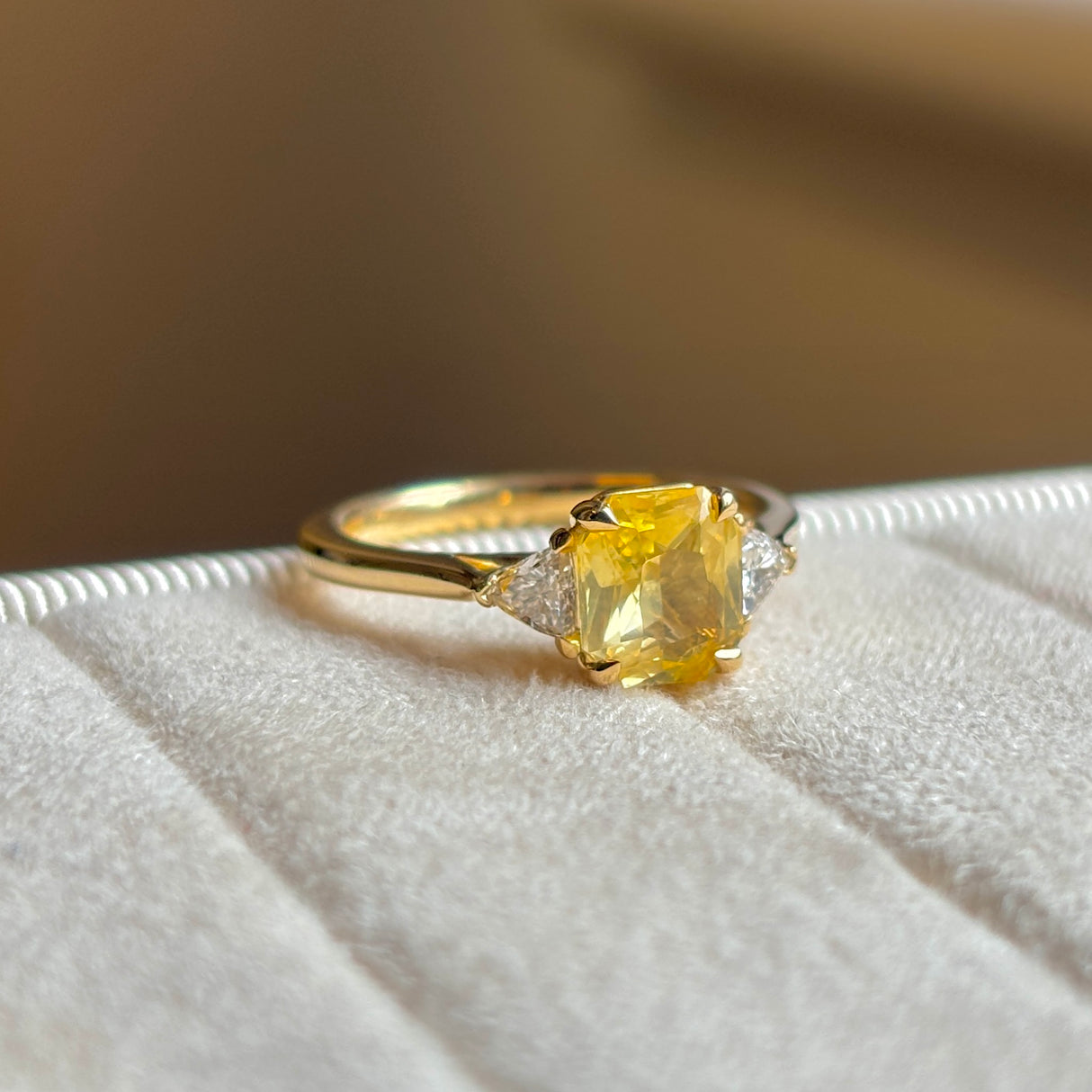 Yellow sapphire and diamond three-stone ring