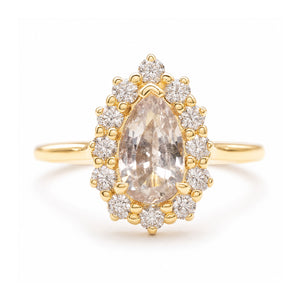 A vintage-inspired, white sapphire and diamond cluster engagement ring set in yellow gold. 