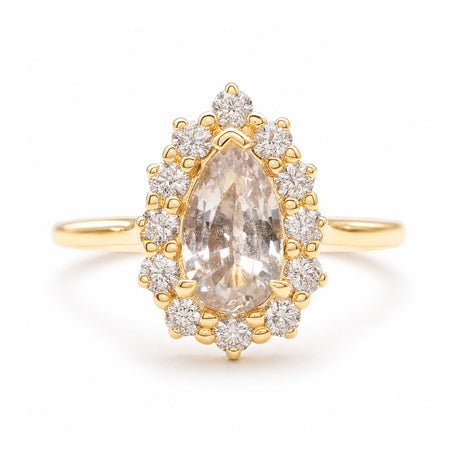 A vintage-inspired, white sapphire and diamond cluster engagement ring set in yellow gold. 