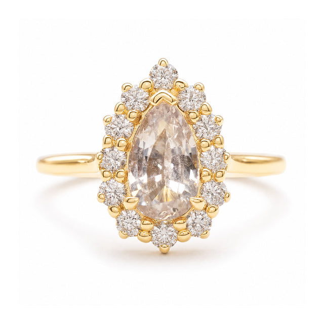 A vintage-inspired, white sapphire and diamond cluster engagement ring set in yellow gold. 
