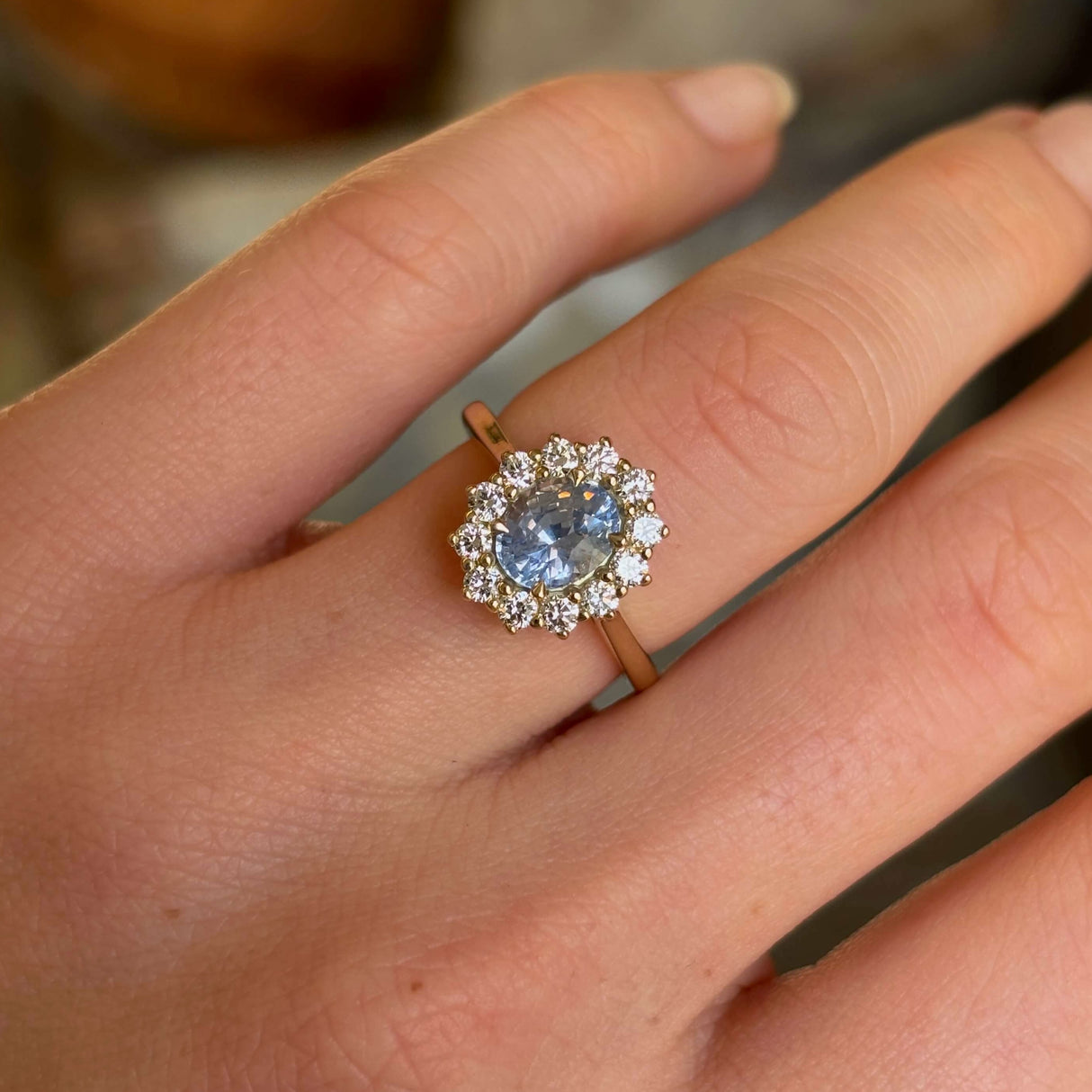 Cornflower blue sapphire and diamond cluster engagement ring